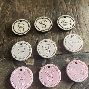 Cute dog-themed wooden tags for knitting or crochet projects, featuring adorable puppy illustrations and customizable options.