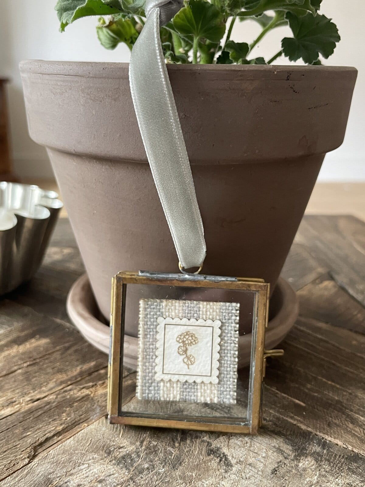 Handmade embroidery yarn charm with floral design for craft projects.