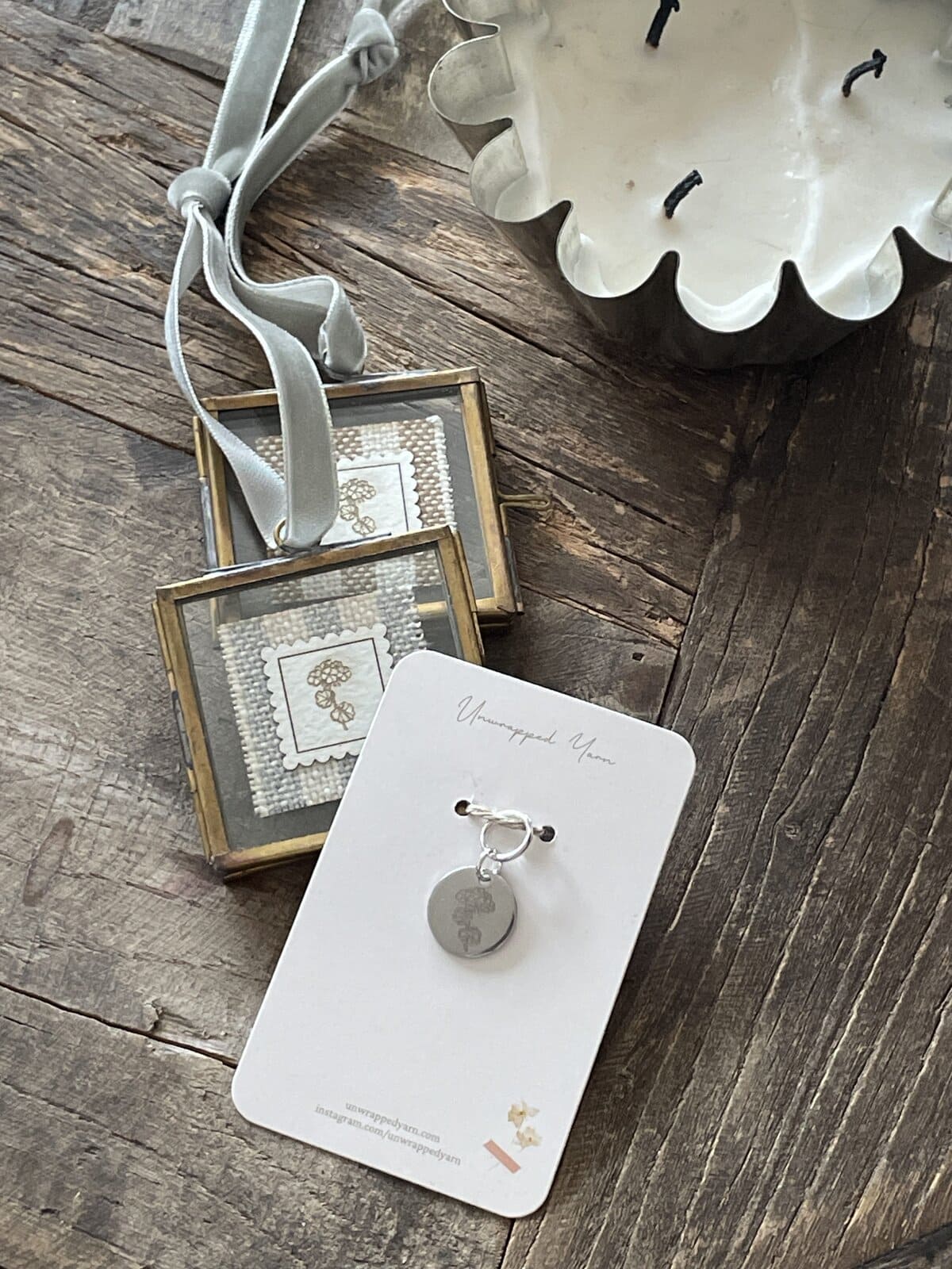 Vintage jewelry display with silver ring, handcrafted accessories, and sentimental keepsakes on rustic wood surface.