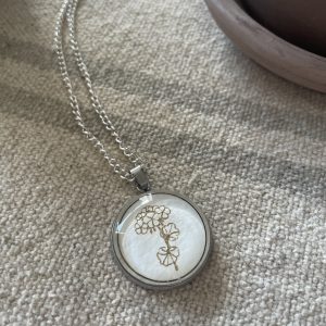 Delicate silver necklace with hydrangea pendant, perfect for jewelry lovers and gift-giving.