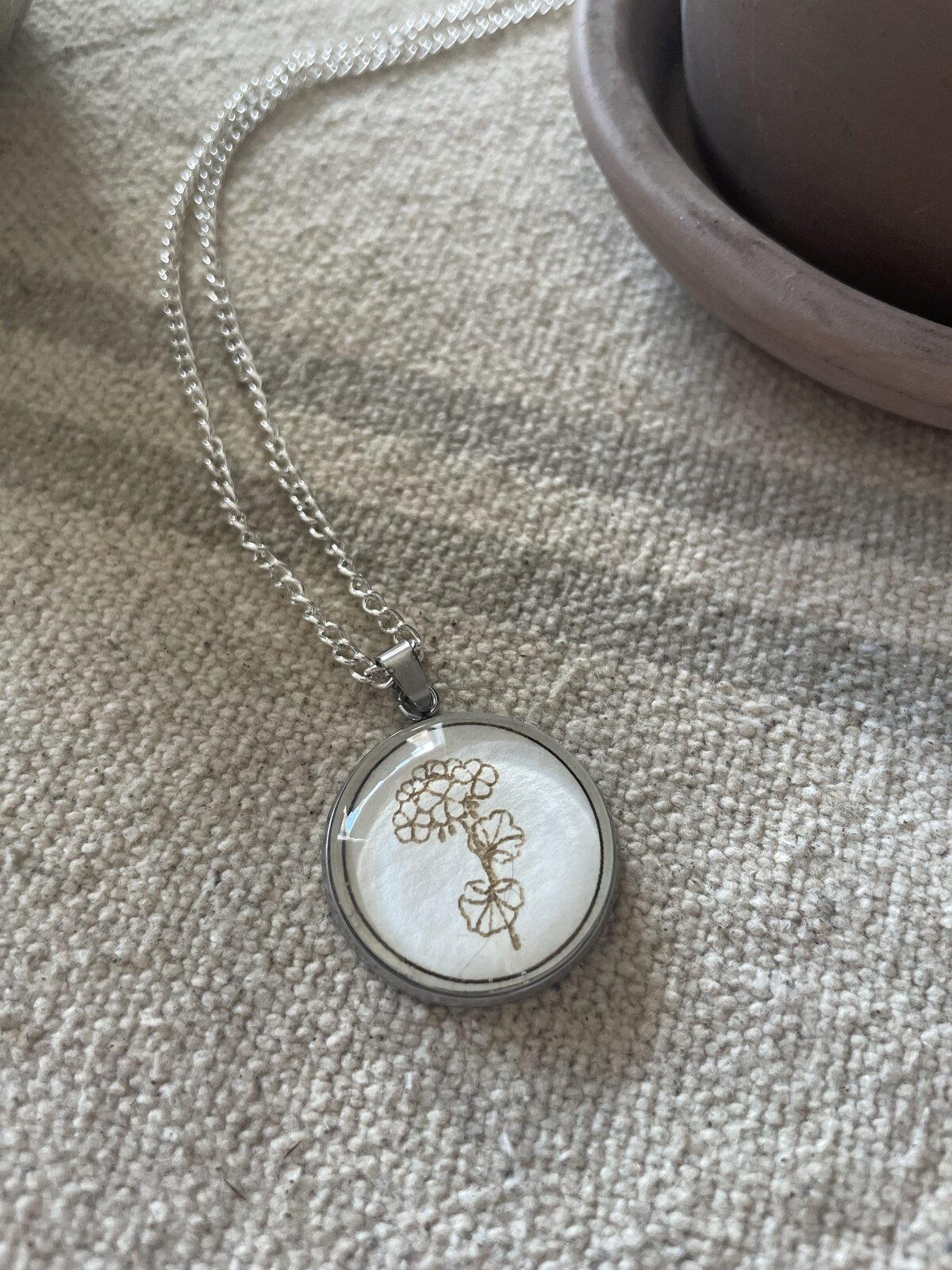 Delicate silver necklace with hydrangea pendant, perfect for jewelry lovers and gift-giving.