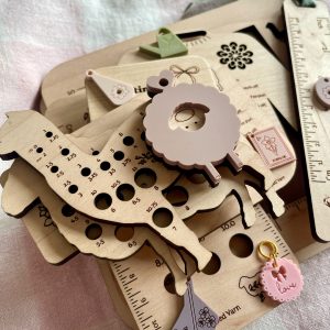 Colorful wooden yarn-related tools and accessories for knitting and crochet projects.