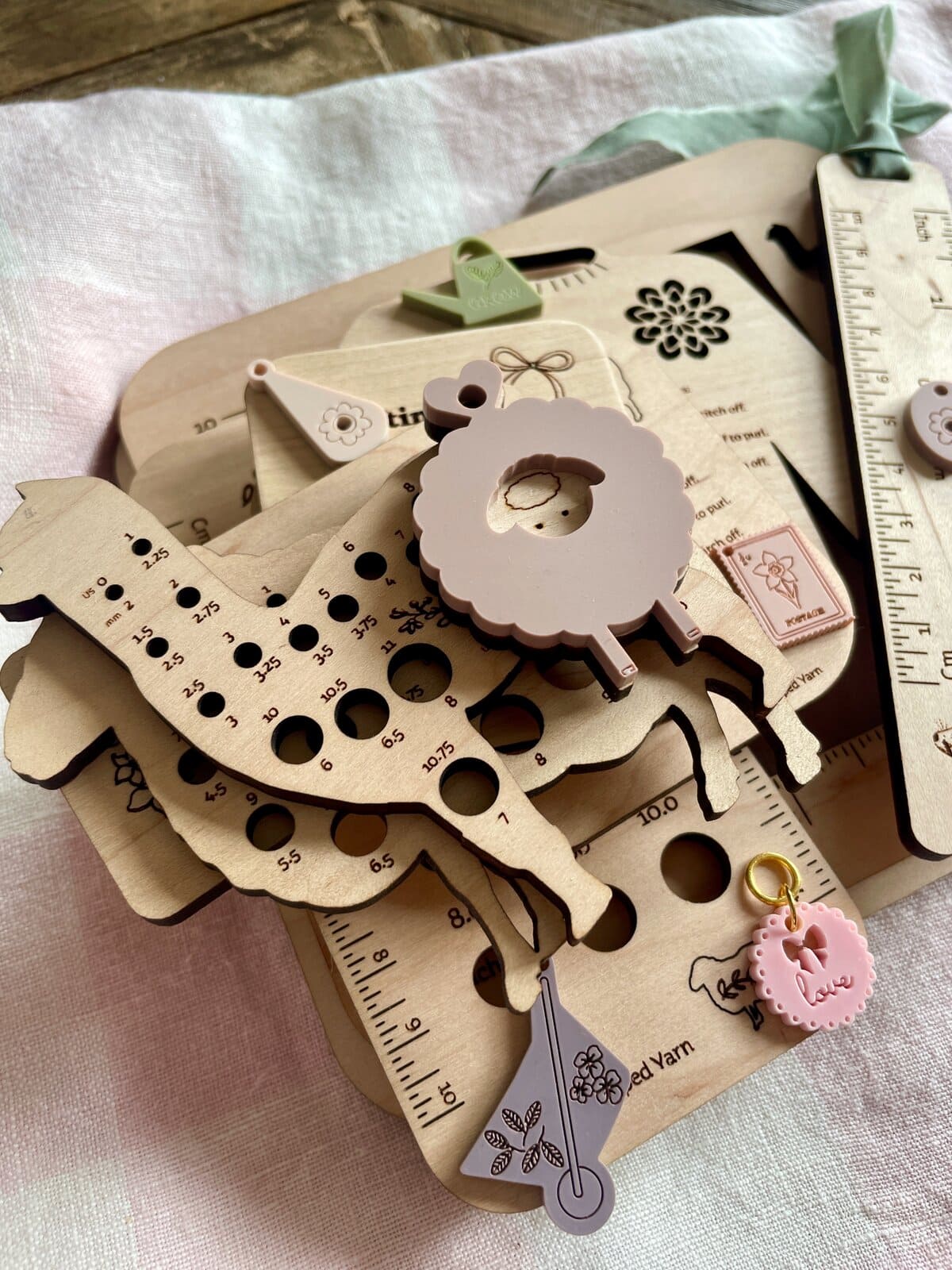 Colorful wooden yarn-related tools and accessories for knitting and crochet projects.