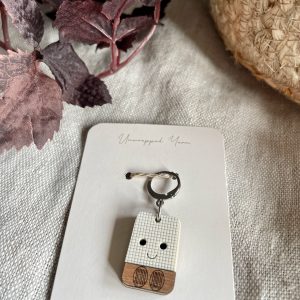 1. Cute smiley face wood keychain on white card from Unwrapped Yarn, yarn craft accessory.