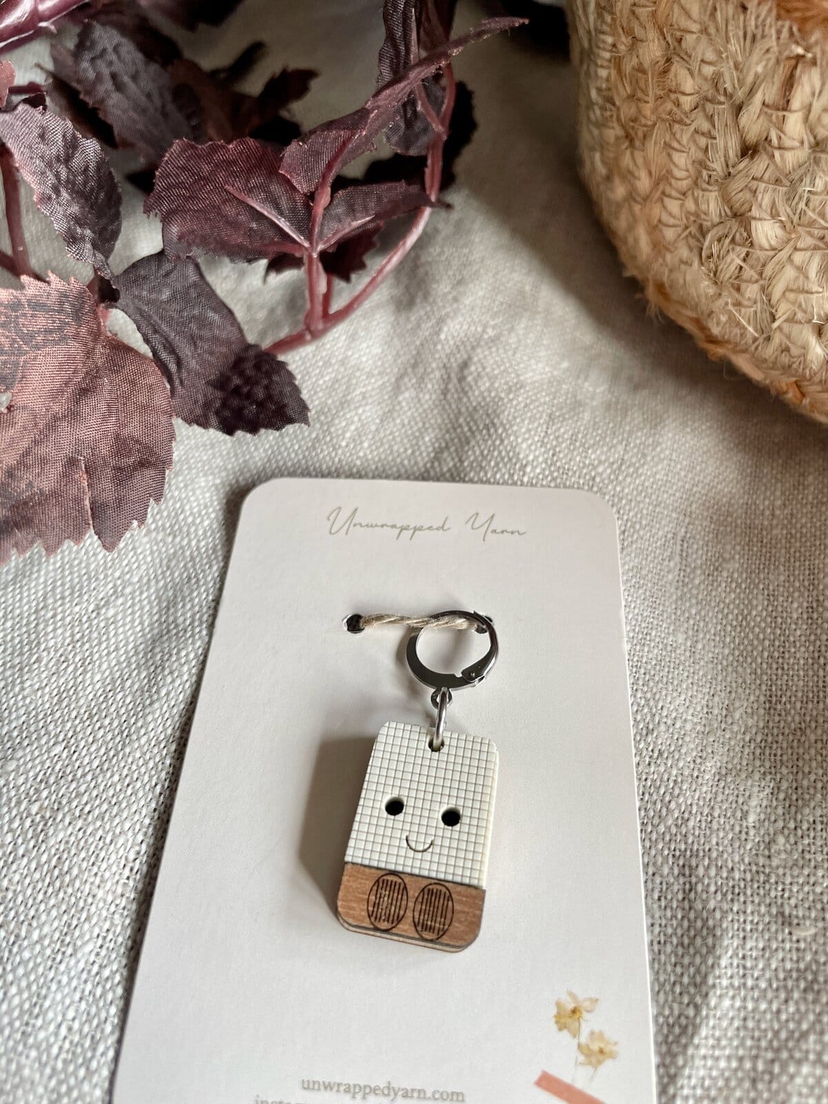 1. Cute smiley face wood keychain on white card from Unwrapped Yarn, yarn craft accessory.