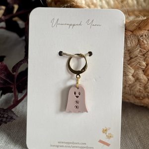 Whimsical ghost-shaped jewelry charm on card, perfect for Halloween or spooky-themed accessories.