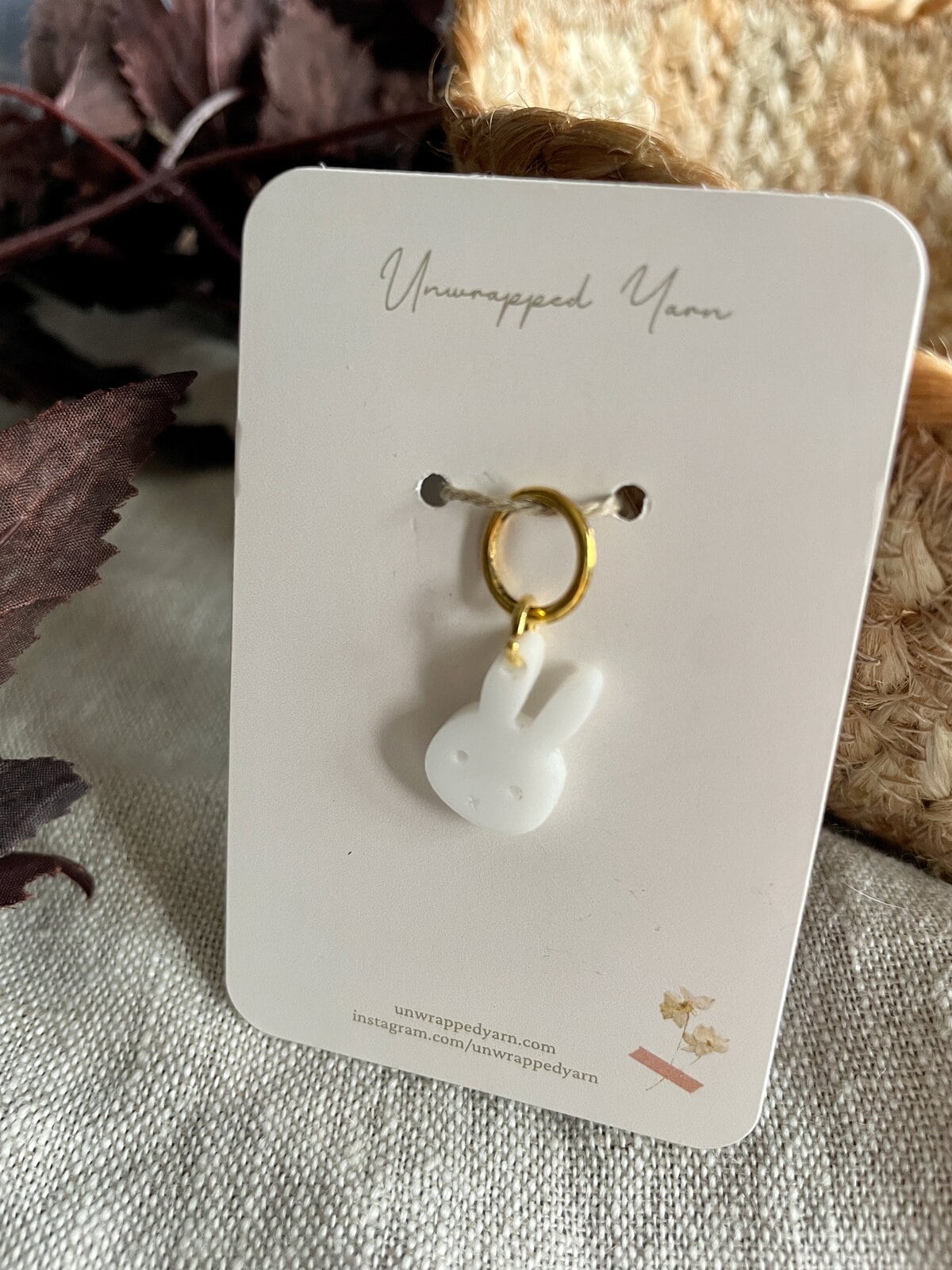 Cute ceramic bunny earring with gold hoop on white jewelry card from Unwrapped Yarn.