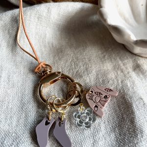 Colorful yarn and jewelry accessories on textured fabric, showcasing handmade crafts and fiber arts.