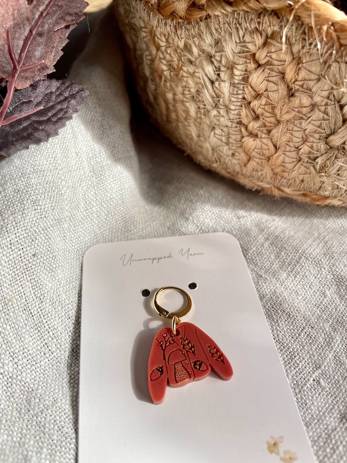 Soft pink embroidered charm keychain with floral design, perfect for crafts and accessories.