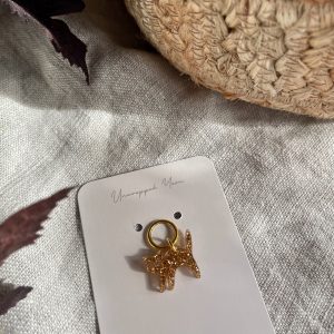 Golden unicorn charm jewelry accessory.