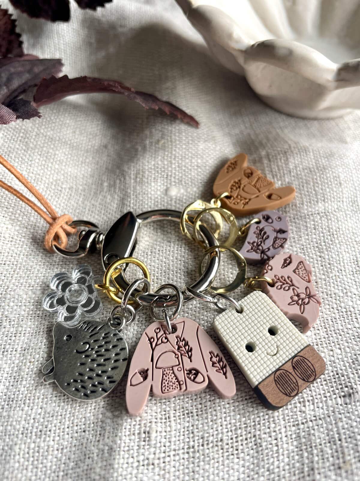 Colorful charm bracelet with floral, animal, and playful character charms, perfect for handcrafted jewelry lovers.