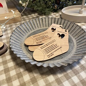 Colorful Christmas yarn and gift tags on rustic table setting, holiday craft supplies, festive decor for knitting projects, and seasonal ambiance.