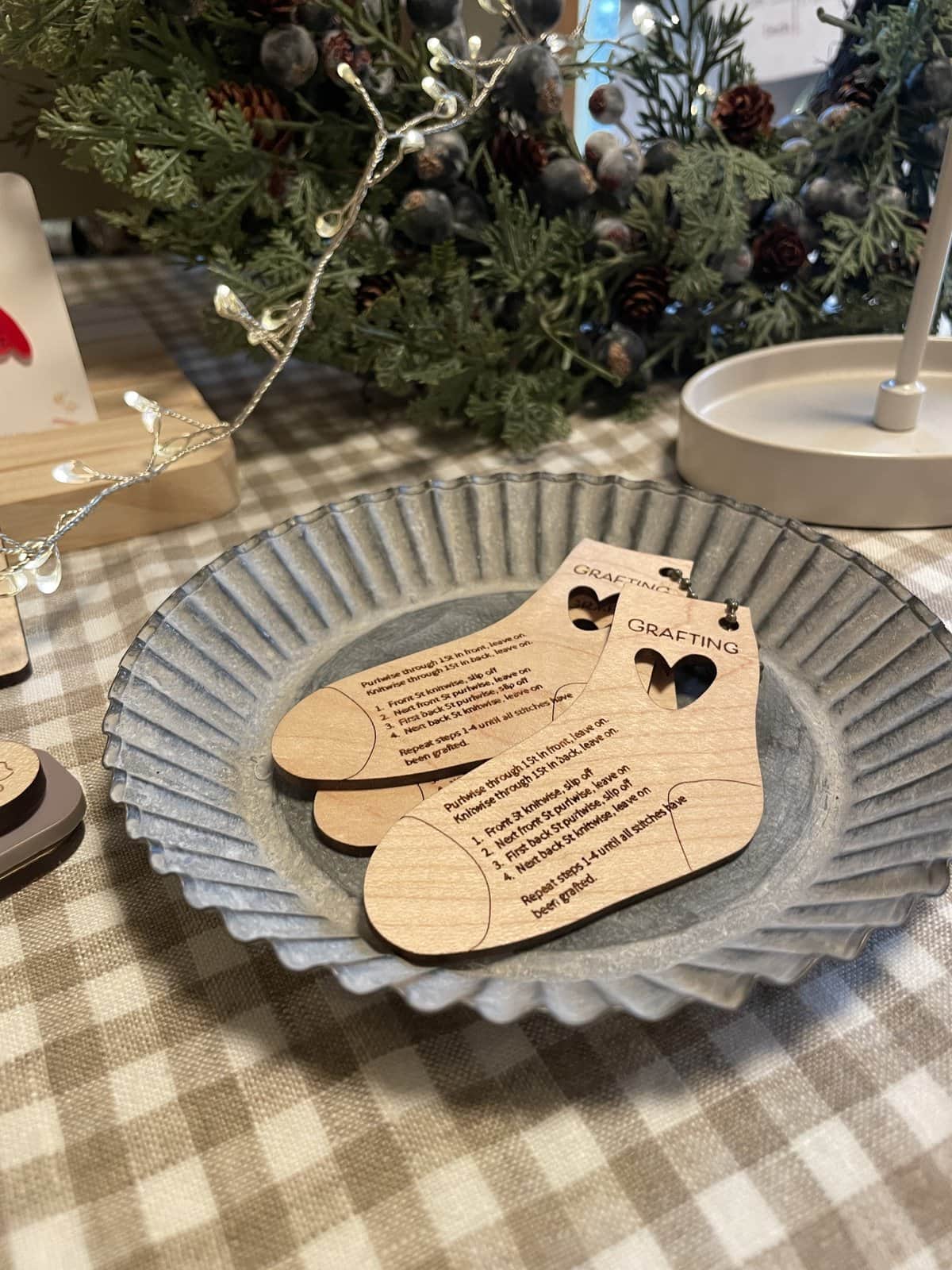 Colorful Christmas yarn and gift tags on rustic table setting, holiday craft supplies, festive decor for knitting projects, and seasonal ambiance.