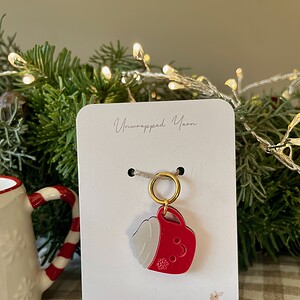 Festive holiday keychain with whipped cream and red soda can design, perfect for Christmas cheer and gift-giving.
