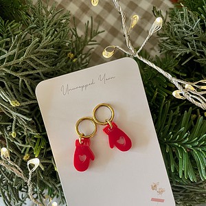 Bright red mitten earrings with heart cutout on gold hoops, perfect for holiday accessories or gift-giving.