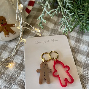 Colorful gingerbread keychains with festive holiday decor and signature on a gift tag.