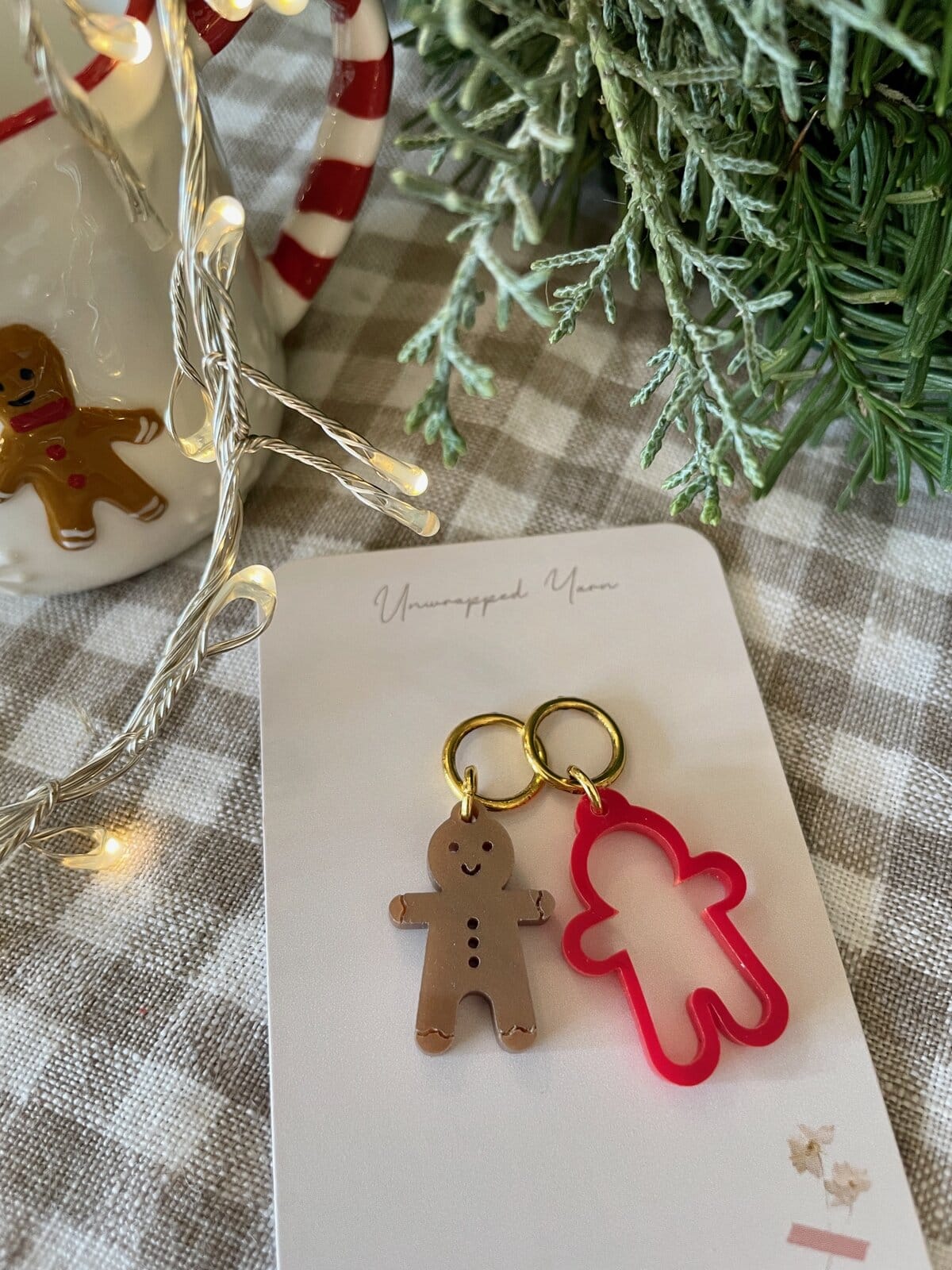 Colorful gingerbread keychains with festive holiday decor and signature on a gift tag.