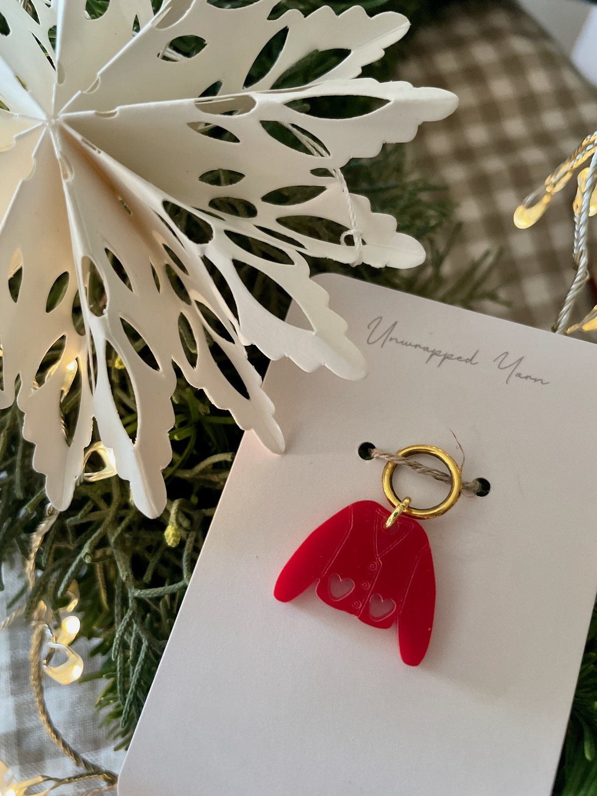 Colorful acrylic angel wing ornament on a holiday gift tag, perfect for Christmas decorations.
