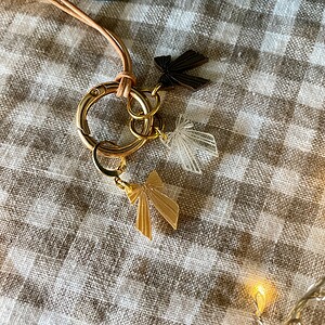Colorful acrylic butterfly keychains on gold rings for crocheting and knitting projects.