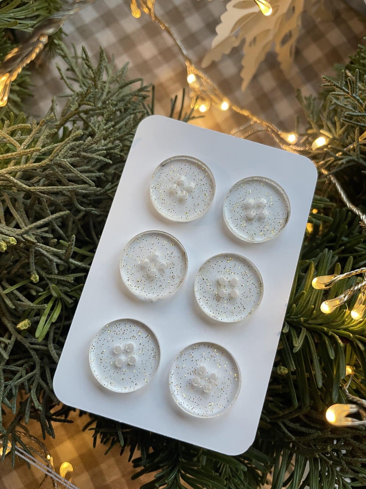 1. Clear wax melts with gold glitter on white silicone mold for festive holiday decor.