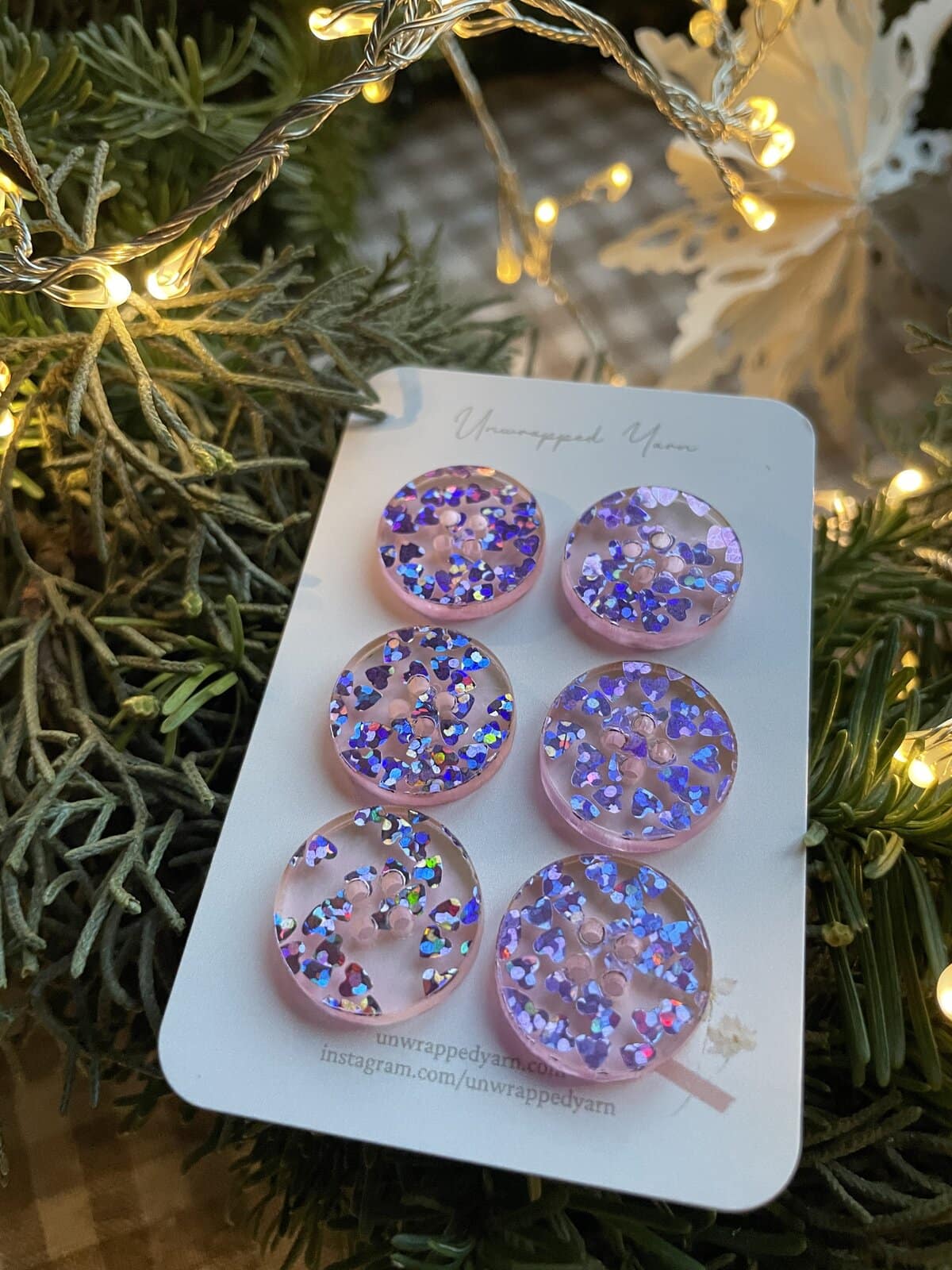 Bright pink resin buttons with iridescent glitter, perfect for craft and apparel embellishments.